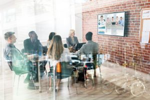 Group Of Businesspeople Having Video Conference In Boardroom